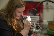 MCC student doing hands-on work in the optics lab